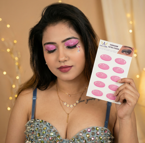 Woman wearing Fairy Wink eye shadow stickers and holding instant eye makeup sticker sheet